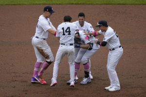 Teammates mob the New York Yankees’ Giancarlo Stanton, center, after he hit a walkoff single during the ninth inning of a game against the Washington Nationals at Yankee Stadium on Sunday in New York.
                                 AP photo