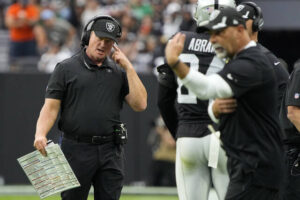 Las Vegas Raiders head coach Jon Gruden speaks on his headset during the first half of an NFL game against the Chicago Bears on Sunday in Las Vegas.
                                 AP photo