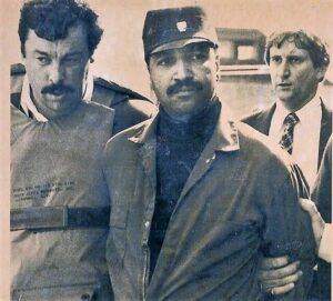 Then-Luzerne County Chief Detective James Zardecki walks George Banks to a waiting police vehicle after being captured on Sept. 25, 1982. At rear is the late Luzerne County District Attorney Robert Gillespie.
                                 AP File Photo