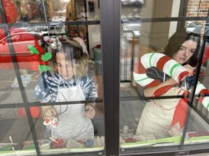 Amelia Grudkowski, left, 19, a student at Ursinus College, and Paicey Clower, 15, a student at Crestwood High School, are seen painting windows at Children’s Service Center, South Franklin Street, Wilkes-Barre, Friday morning. Both are students of Sue Hand Imagery, Dallas.
                                 Bill O’Boyle | Times Leader