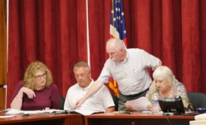 Luzerne County Planning/Zoning senior planner Patrick Dooley (standing) shows development plans to Planning Commission members, from left, Karen Fleisher, William Kane and Vice Chairwoman Cinda Hartman during a proceeding Thursday at the county courthouse in Wilkes-Barre.
                                 Jennifer Learn-Andes | Times Leader