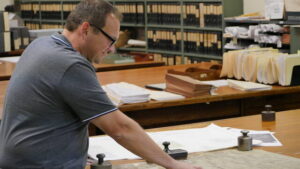 Terence Ostrowski, CEO/President of Earth Conservancy, reviews an 1894 map showing the original path of Espy Run in Hanover Township before it was diverted into strip mines.
                                 Jennifer Learn-Andes|Times Leader