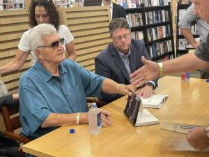 A man extends his hand to shake the hand of William ‘Big Billy’ D’Elia at Friday evening’s book signing at Barnes & Noble in the Arena Hub Plaza. At right is Matt Birkbeck, author of ‘The Life We Chose: William ‘Big Billy’ D’Elia and the Last Secrets of America’s Most Powerful Mafia Family.’
                                 Bill O’Boyle | Times Leader