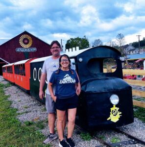 Allen and Sarah Retherford stand by The Zain Train, which is the former miniature train that operated at Hansons Amusement Park at Harveys Lake. The Zain Train, named for their son, championship wrestler Zain Retherford, now operates at Retherfords Farm Market in Benton Township, Columbia County.
                                 Submitted Photo