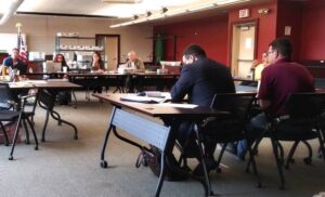 Republican state representative candidate Jamie Walsh, at right in the foreground, and his attorney, Carter Hoel of Pittsburgh, listen to Luzerne County Election Board members during Tuesday’s adjudication.
                                 Jennifer Learn-Andes | Times Leader