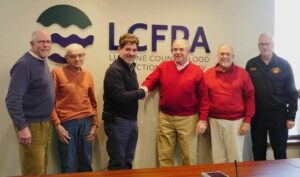 Luzerne County Flood Protection Authority Executive Director Christopher Belleman, fourth from left, is congratulated following Tuesdays meeting  the last before his Jan. 9 retirement. Authority Board members, from left, are: Vice Chairman William Hardwick, John Maday, Chairman Dominic Yannuzzi, Coray Mitchell and Jay Delaney.
                                 Jennifer Learn-Andes | Times Leader
